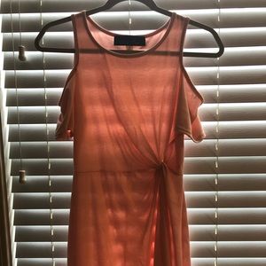 Peach colored dress with a tie.